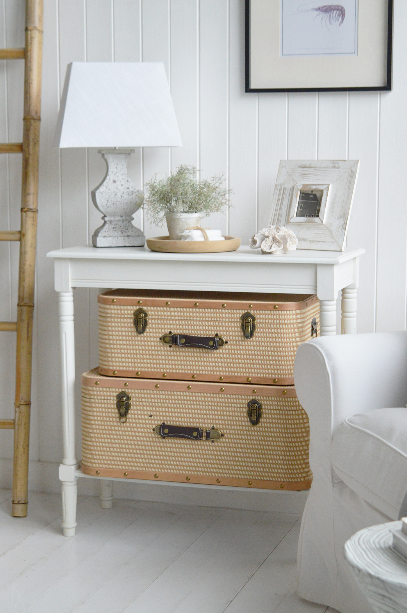 Soft white walls, painted wood floors, and natural textures form the foundation of classic coastal cottage interiors.