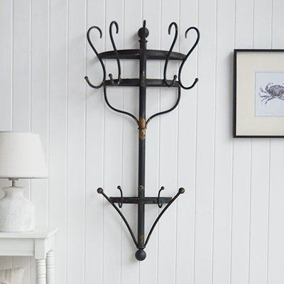 Shop the Brentwood metal coat rack, a vintage-style wall-mounted rack with curved hooks and a distressed black finish for stylish hallway storage.