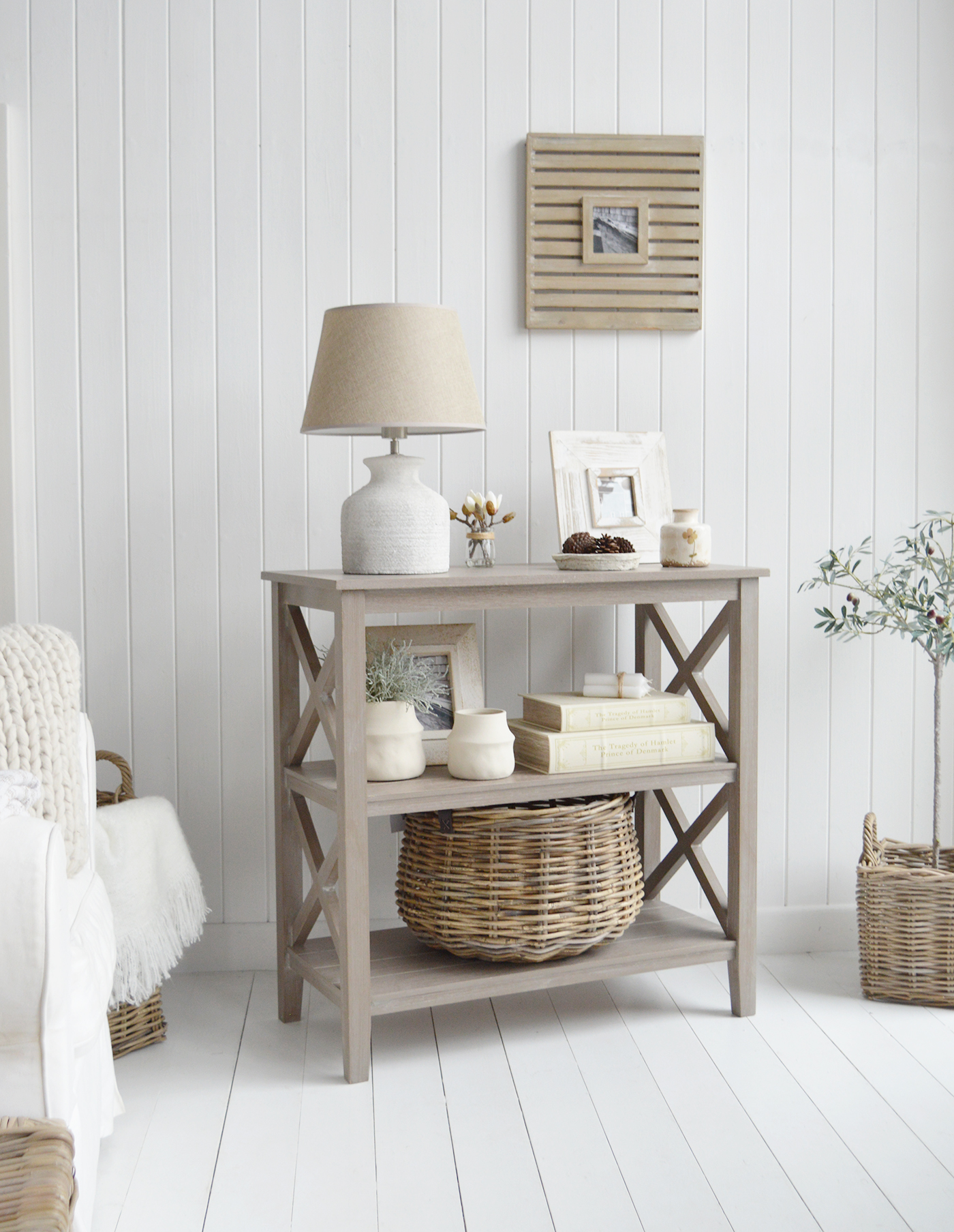 The driftwood grey console table with shelves in a coastal styled living room