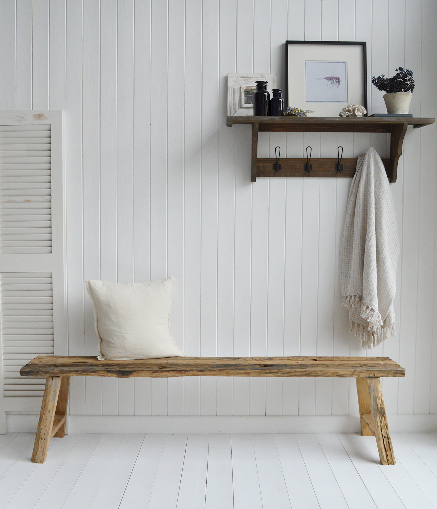 Handcrafted driftwood bench in white Hamptons-style entryway