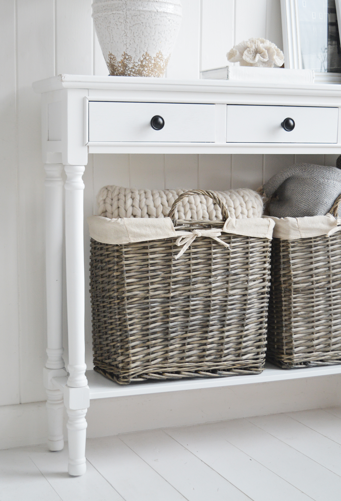 The Windsoe basket tidy under the narrow Georgetown white console table