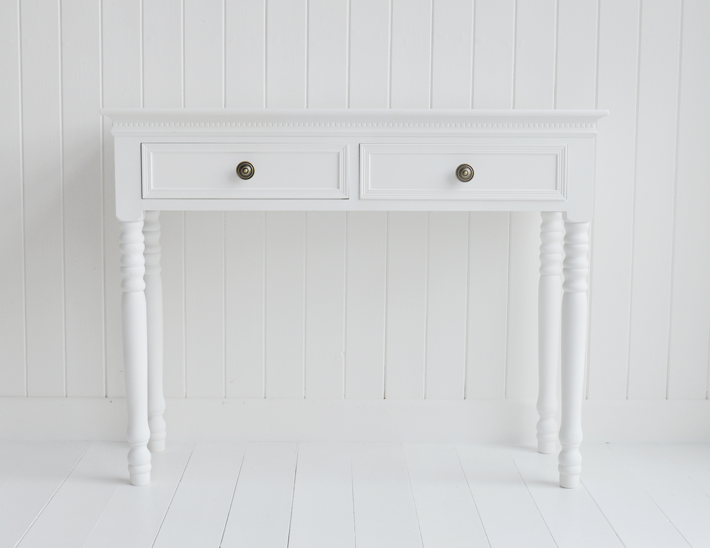 The New England white dressing table with 2 drawers and antique brass handles from The White Lighthouse range of bedroom dressers and furniture. Coastal, country, cottage and city bedroom interiors and decor