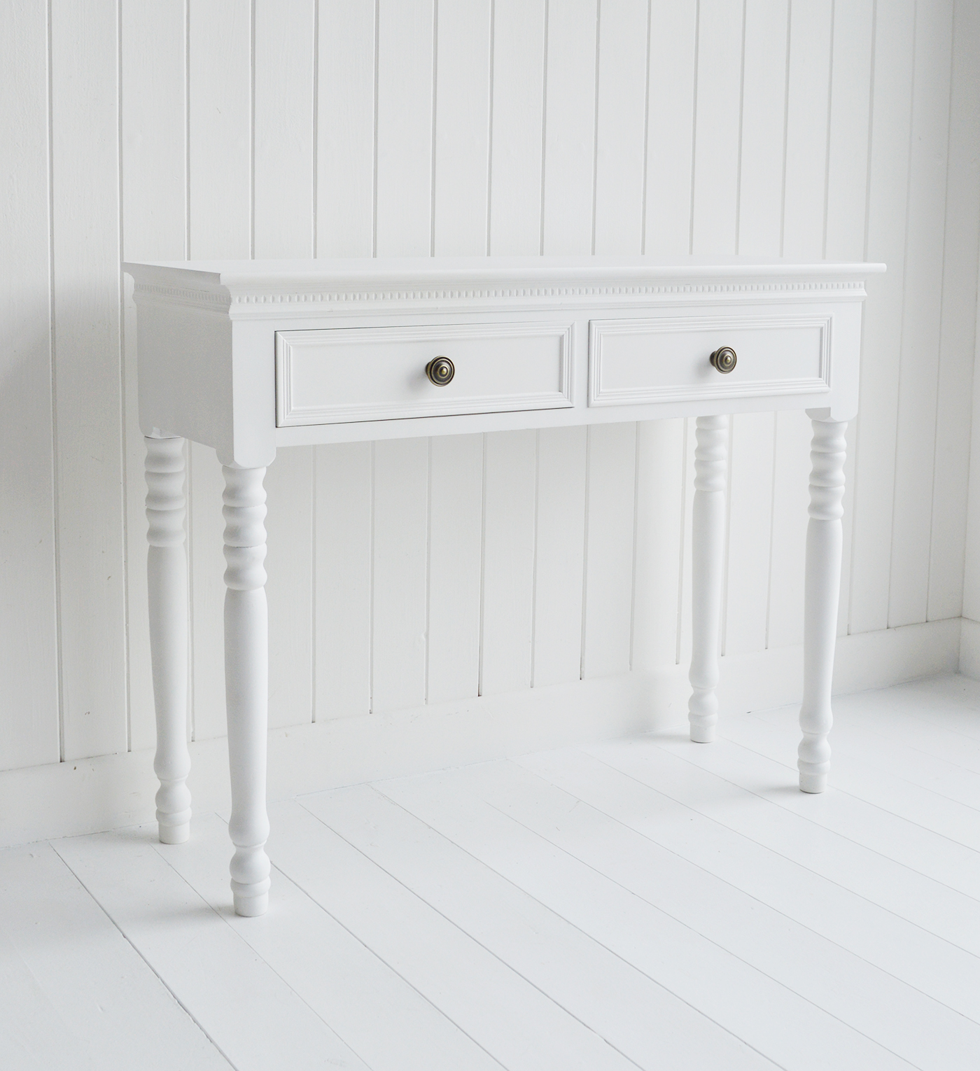 The New England white dressing table with 2 drawers and antique brass handles from The White Lighthouse range of bedroom dressers and furniture. Coastal, country, cottage and city bedroom interiors and decor