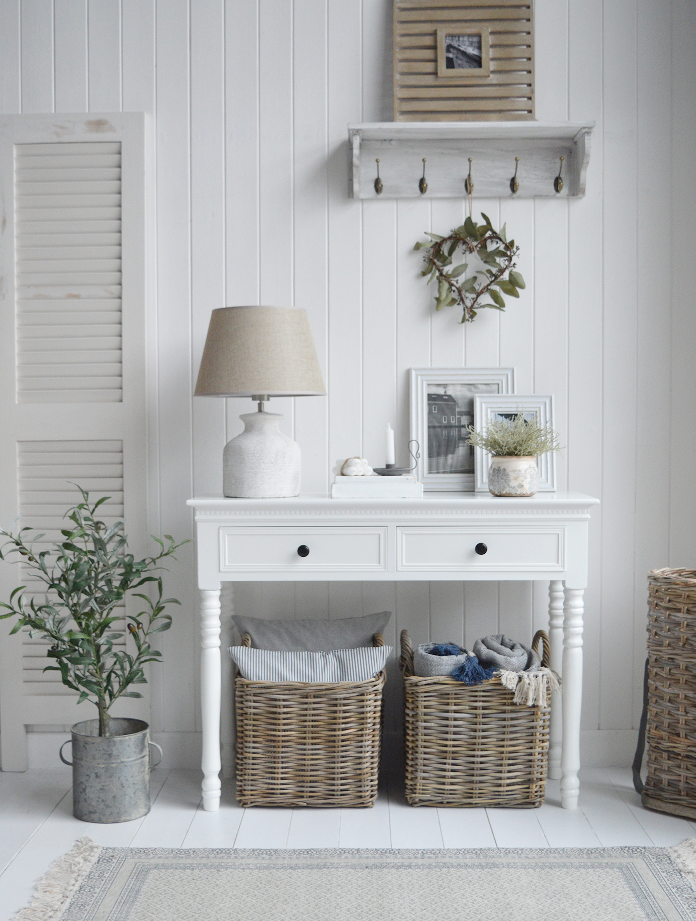 Neew England white console table alongside the faux olive tree in a zinc pot. 