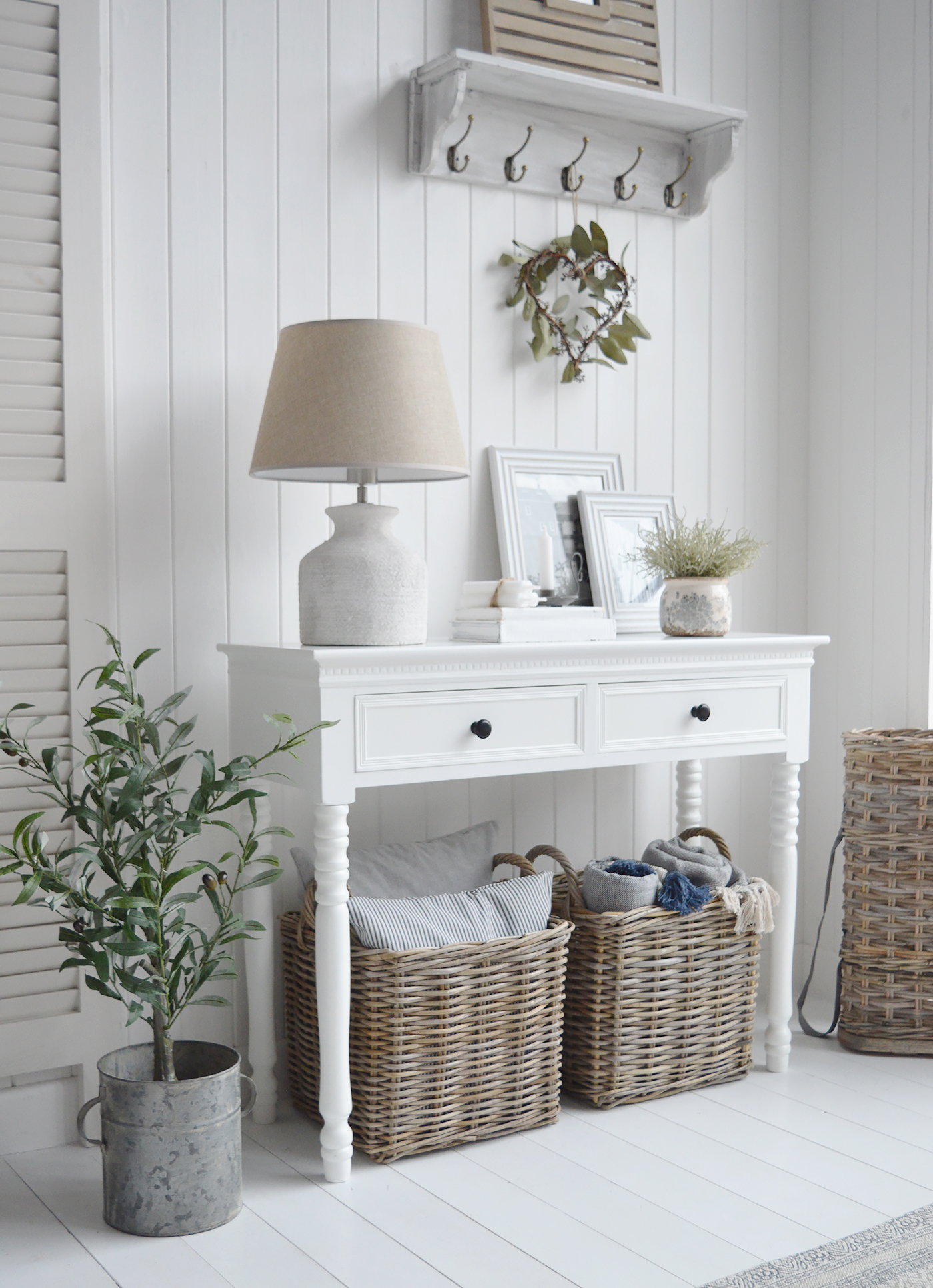 A side view of the white New England console table with two drawers, this version being with black handles. Perfect piece of furniture in Coastal, country and modern farmhouse styled homes and interiors