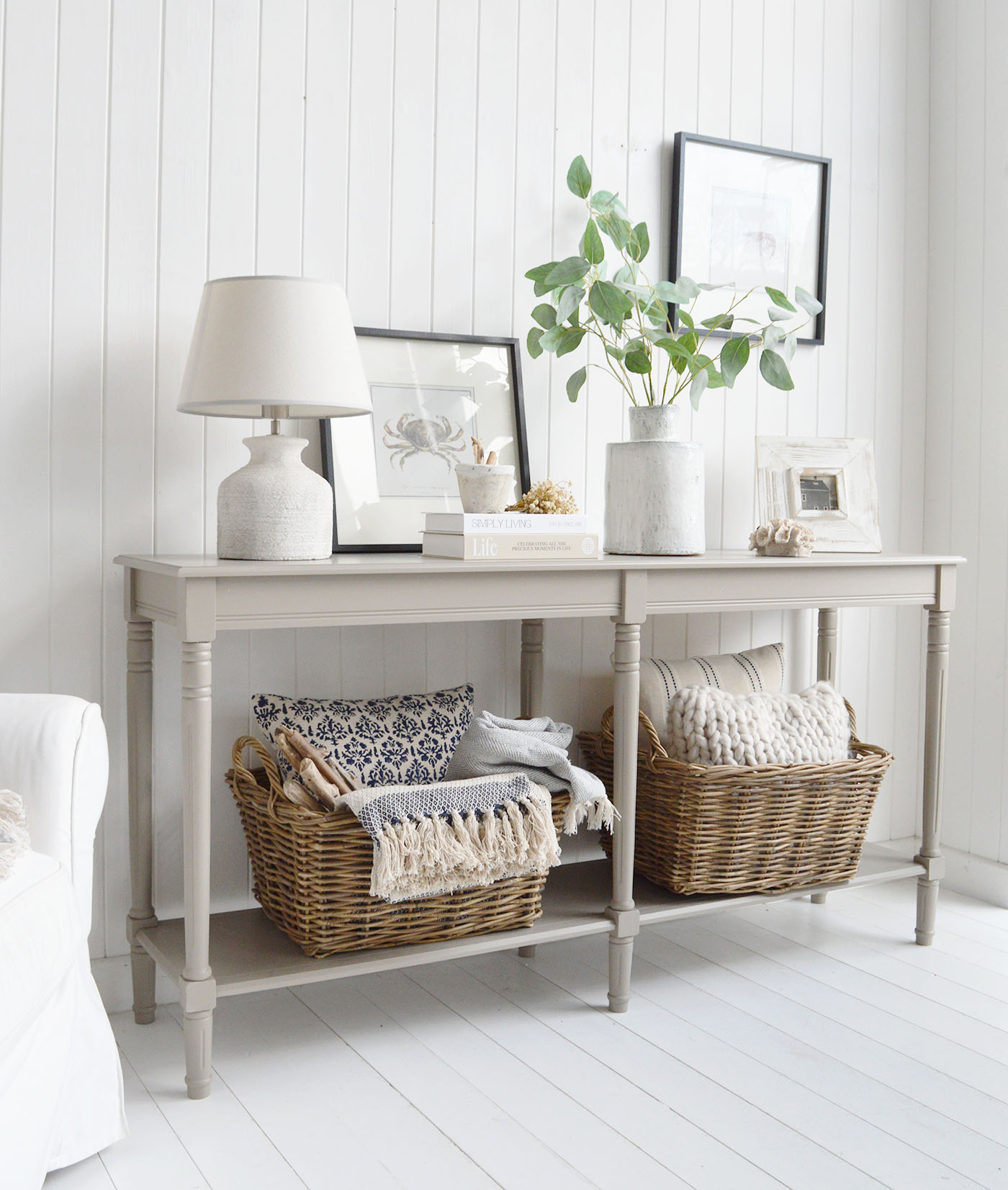 With its neutral painted finish and classic turned legs, this coastal console table adds effortless beach house style to any space.