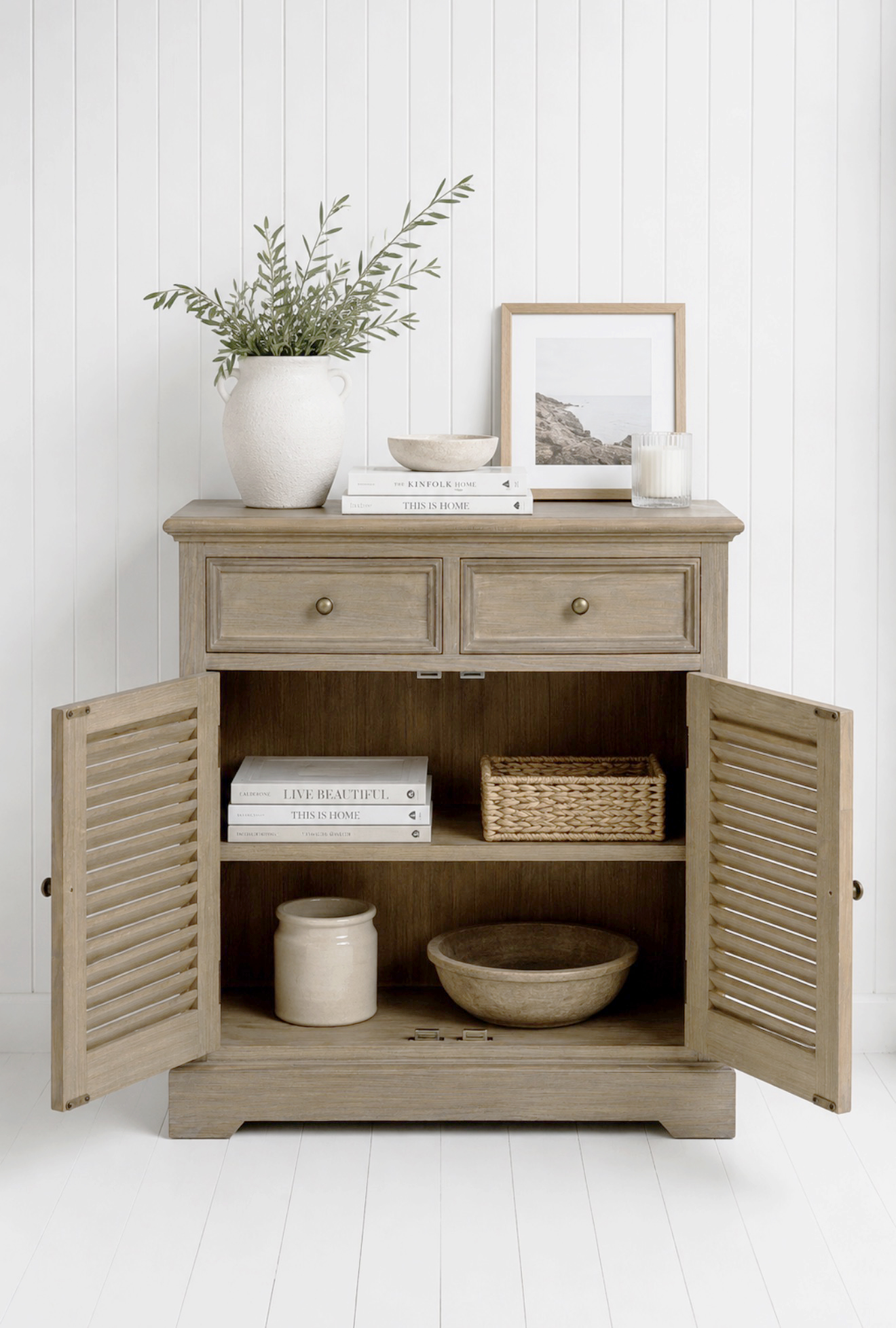 Crafted in a weathered natural wood finish with antique brass-effect handles, the Portsmouth Cabinet brings warmth, texture and relaxed coastal charm to any neutral home.