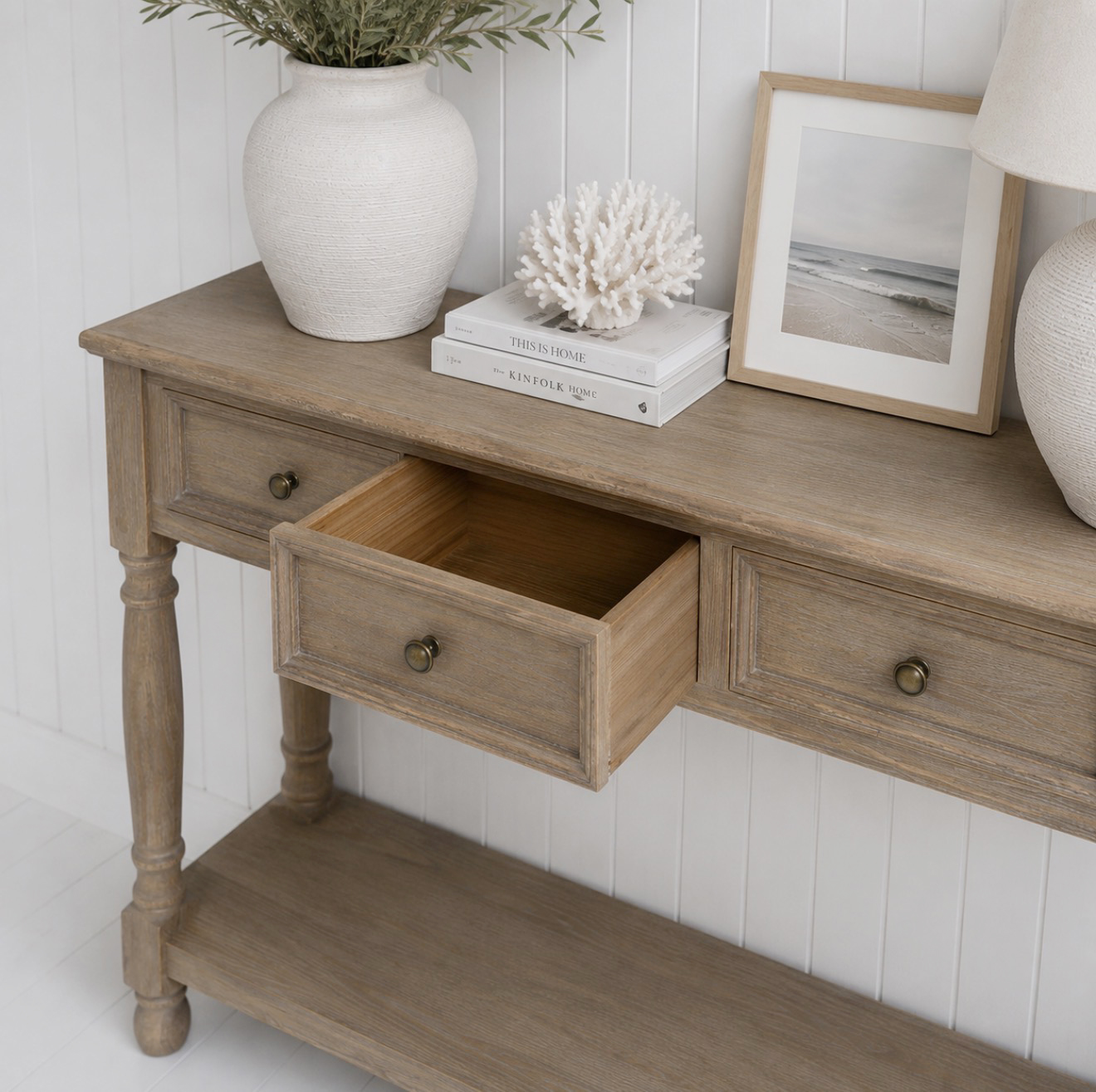 Crafted in a warm natural wood finish, the Portsmouth Console Table brings classic coastal charm and effortless elegance to neutral interiors.