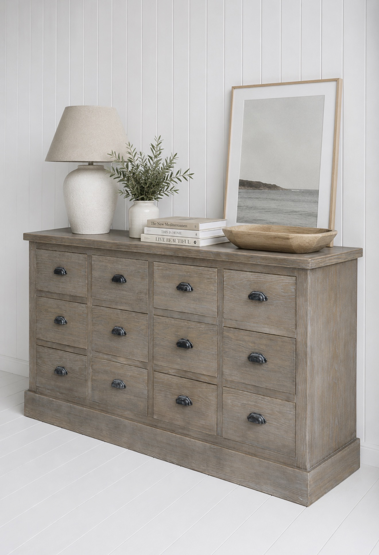 Crafted from wood with a soft weathered finish, this coastal chest of drawers brings warmth, texture and character to neutral interiors.