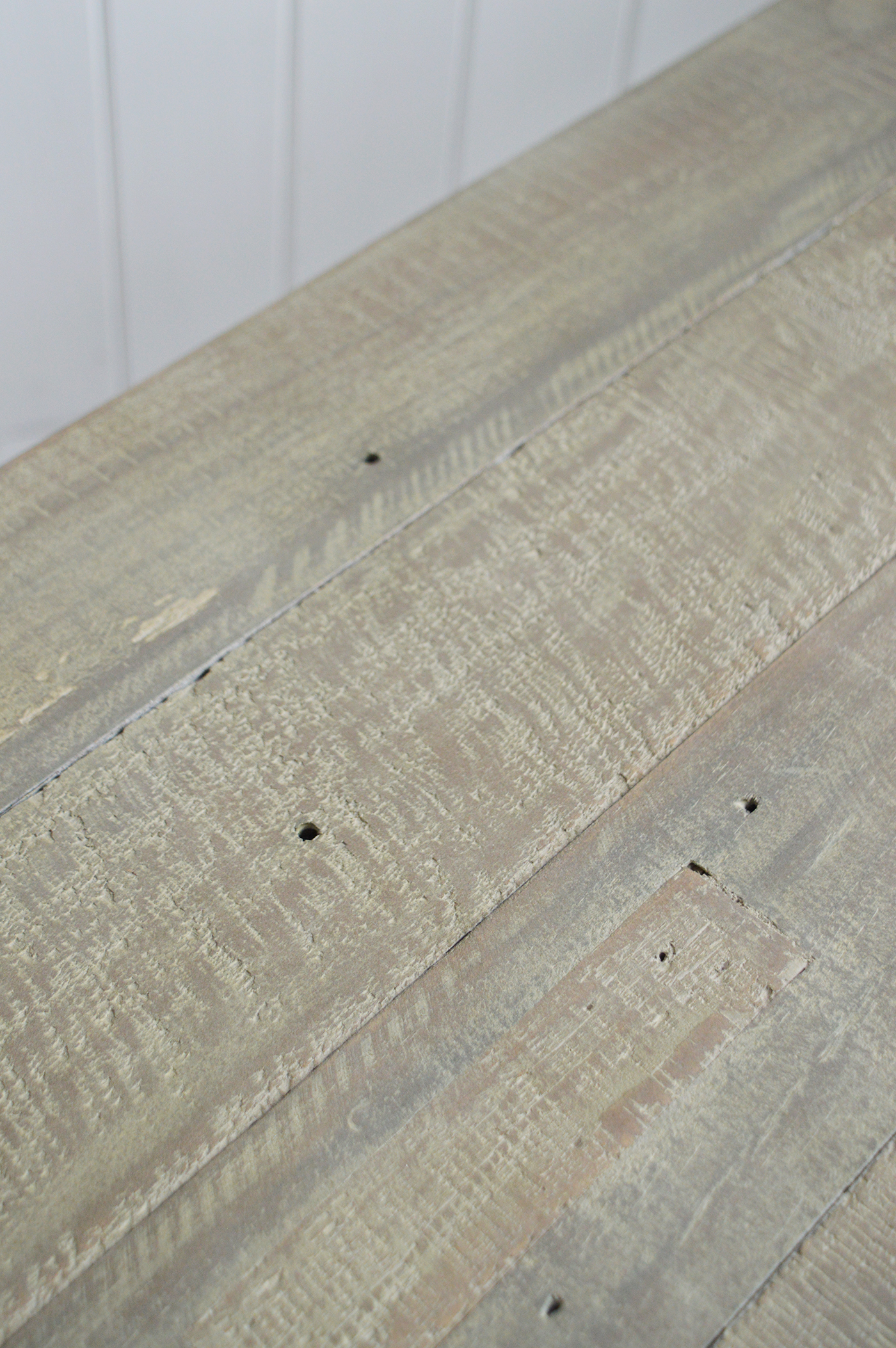 Rustic-style wooden bench with natural texture and soft grey tones