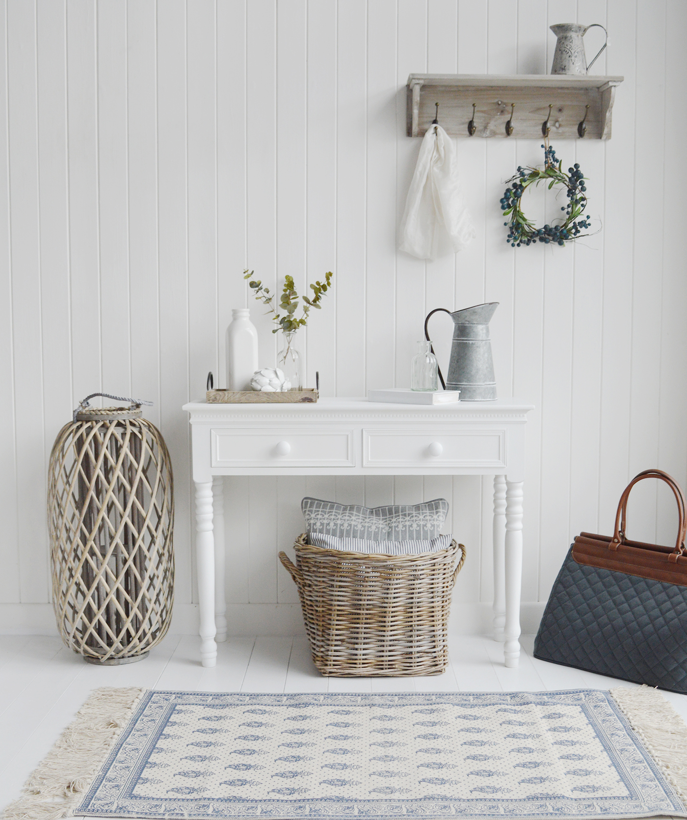 A white console or hallway table with two drawers for essential storage and white wooden knob handles.

A very simple but elegant pure white table for hall or living room interiors.

The New England Range is a crisp matt white range of furniture for a classic look to any room. As perfectly suitable for coastal interiors as it is for Victorian or country homes. The New England table with brighten and beautify all all rooms.

The console table comprises of turned pine legs finished with several layers of white satin paint.