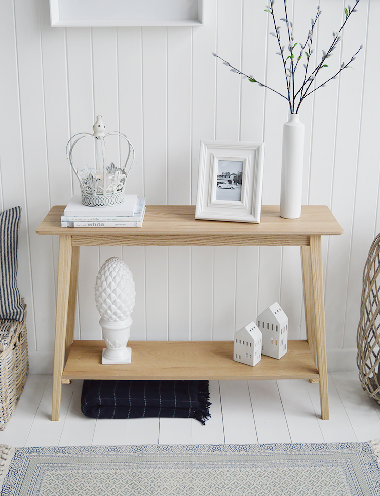 Specifically designed for narrow hallways our New Shoreham hall table is a perfect choice at only 30cm deep at the widest top. In a light coloured wood veneer the table will impeccably complement all home interiors and styles. A traditional  simple design with the straight lines giving it a modern touch.The shelf adds to the look of the table as well as offering an area for display or storage…