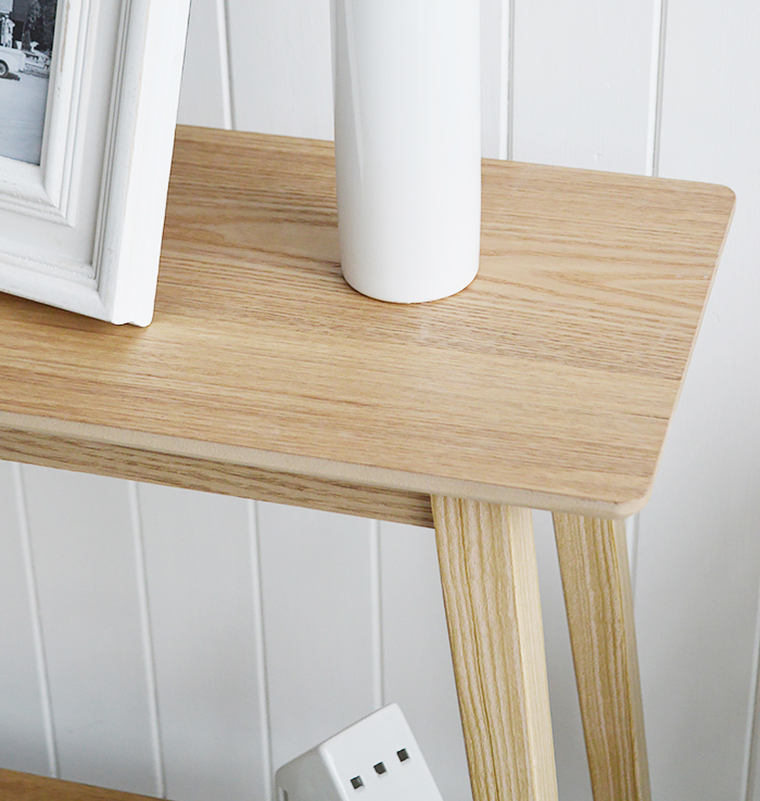 Specifically designed for narrow hallways our New Shoreham hall table is a perfect choice at only 30cm deep at the widest top. In a light coloured wood veneer the table will impeccably complement all home interiors and styles. A traditional  simple design with the straight lines giving it a modern touch.The shelf adds to the look of the table as well as offering an area for display or storage…