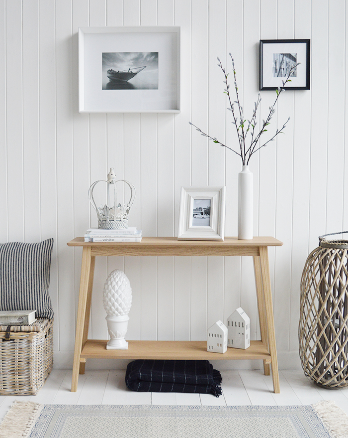 Specifically designed for narrow hallways our New Shoreham hall table is a perfect choice at only 30cm deep at the widest top. In a light coloured wood veneer the table will impeccably complement all home interiors and styles. A traditional  simple design with the straight lines giving it a modern touch.The shelf adds to the look of the table as well as offering an area for display or storage…