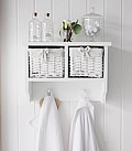 White wall shelf with small baskets