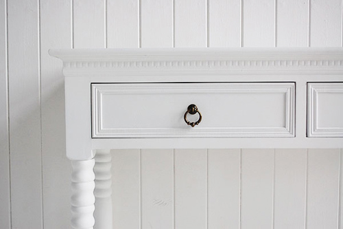New England white console table with antique brass handles on each drawer