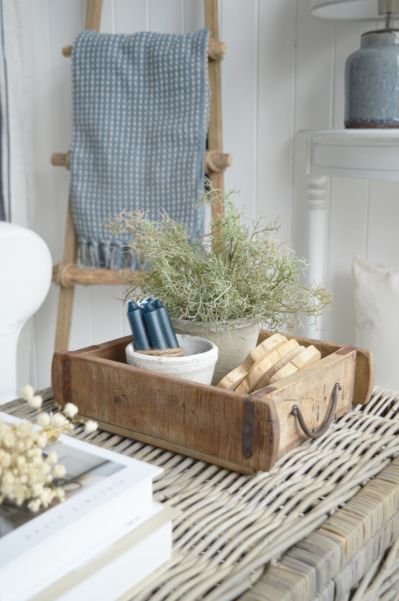 Soft blue textiles make the white armchair feel comfortable and inviting.