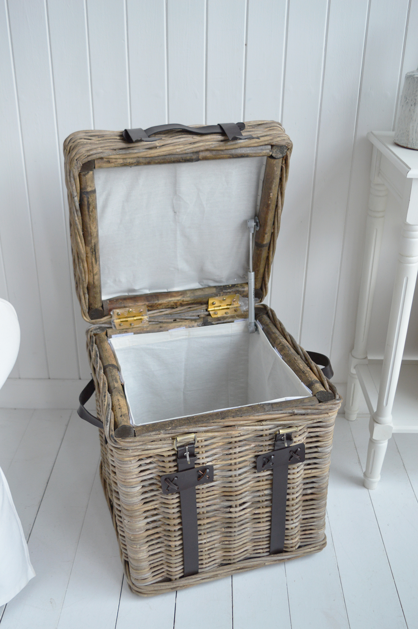 Perfect beside a white sofa, this basket side table adds warmth to a soft neutral interior.
