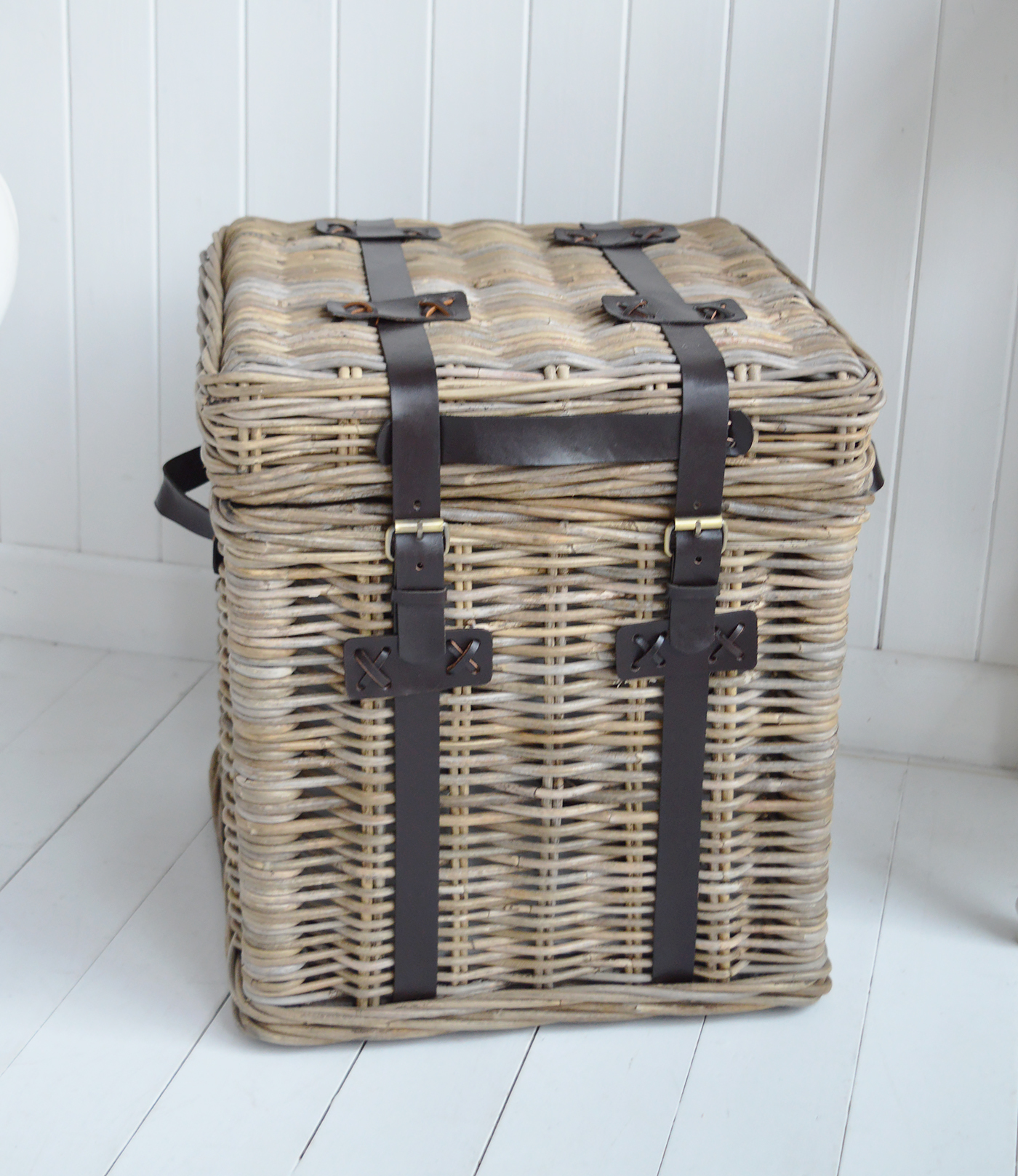 Woven rattan and rich leather straps give the Casco Bay side table its distinctive New England style.