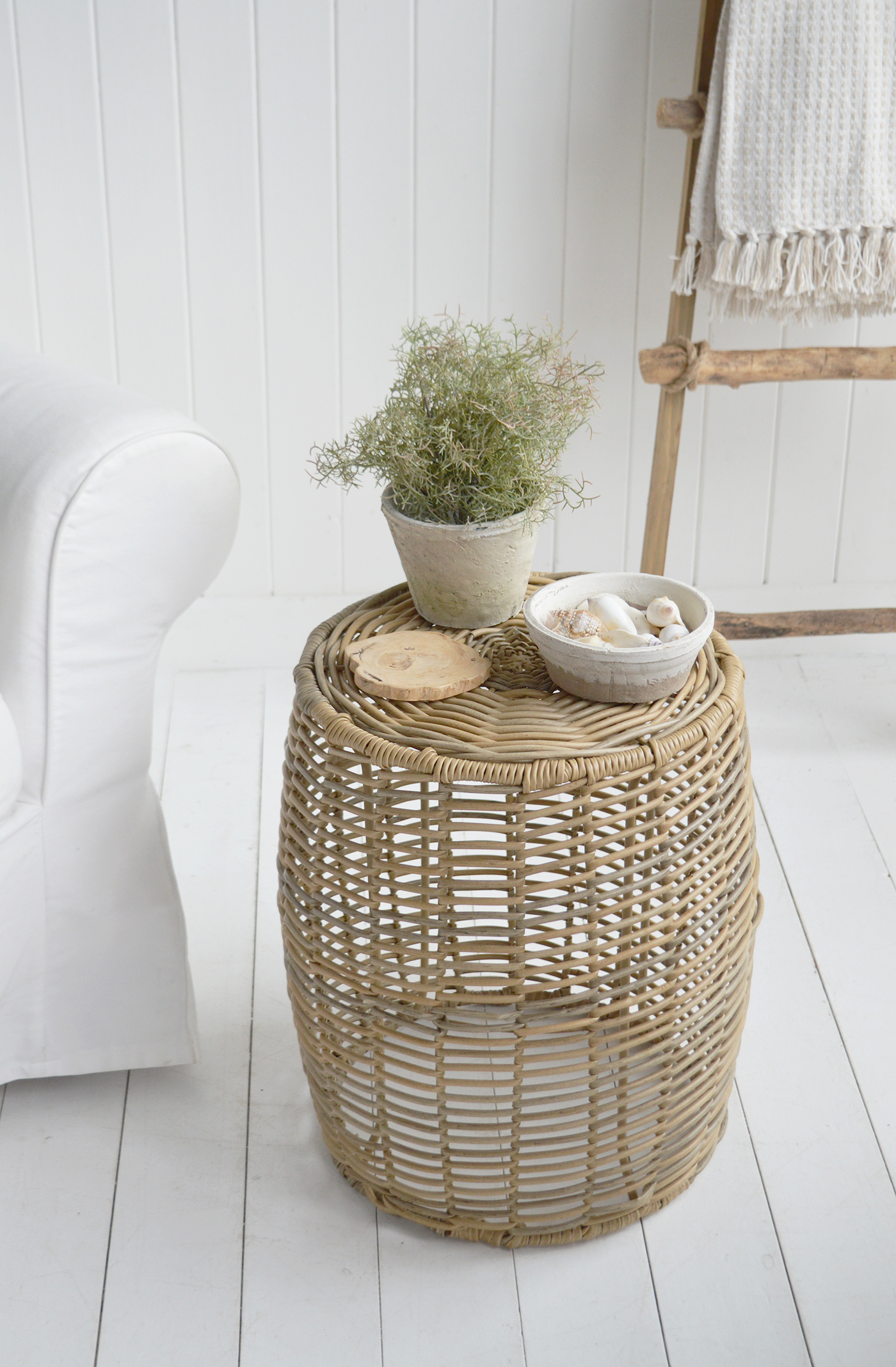The Casco Bay stool brings woven texture and soft sandy tones to a coastal living room.