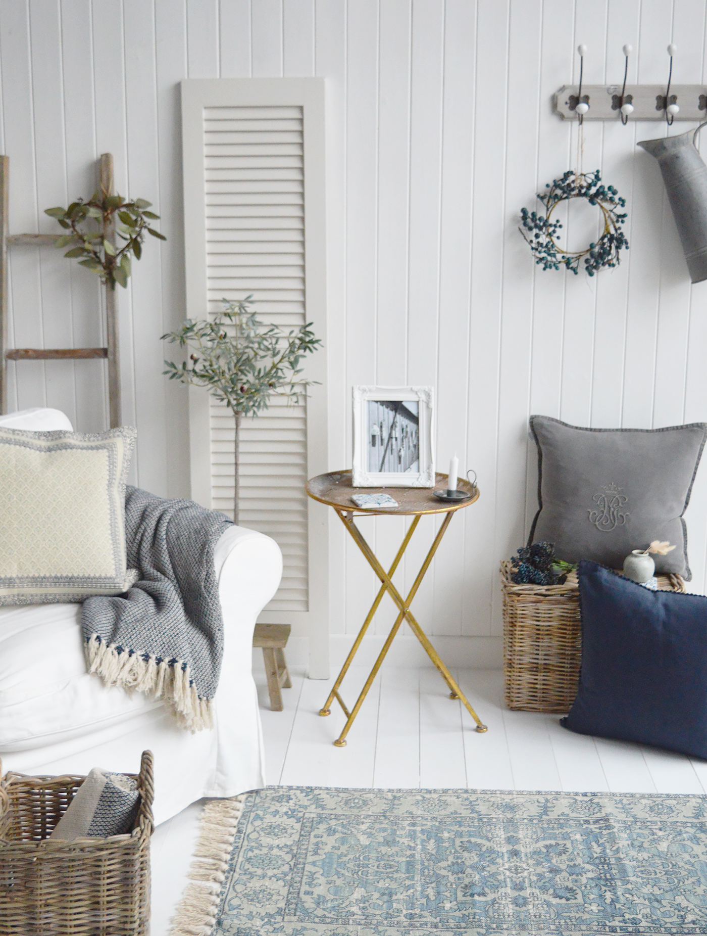 The Charleston antiqued gold folding table alongside the our artificial Olive tree and our New England style cushions and throws