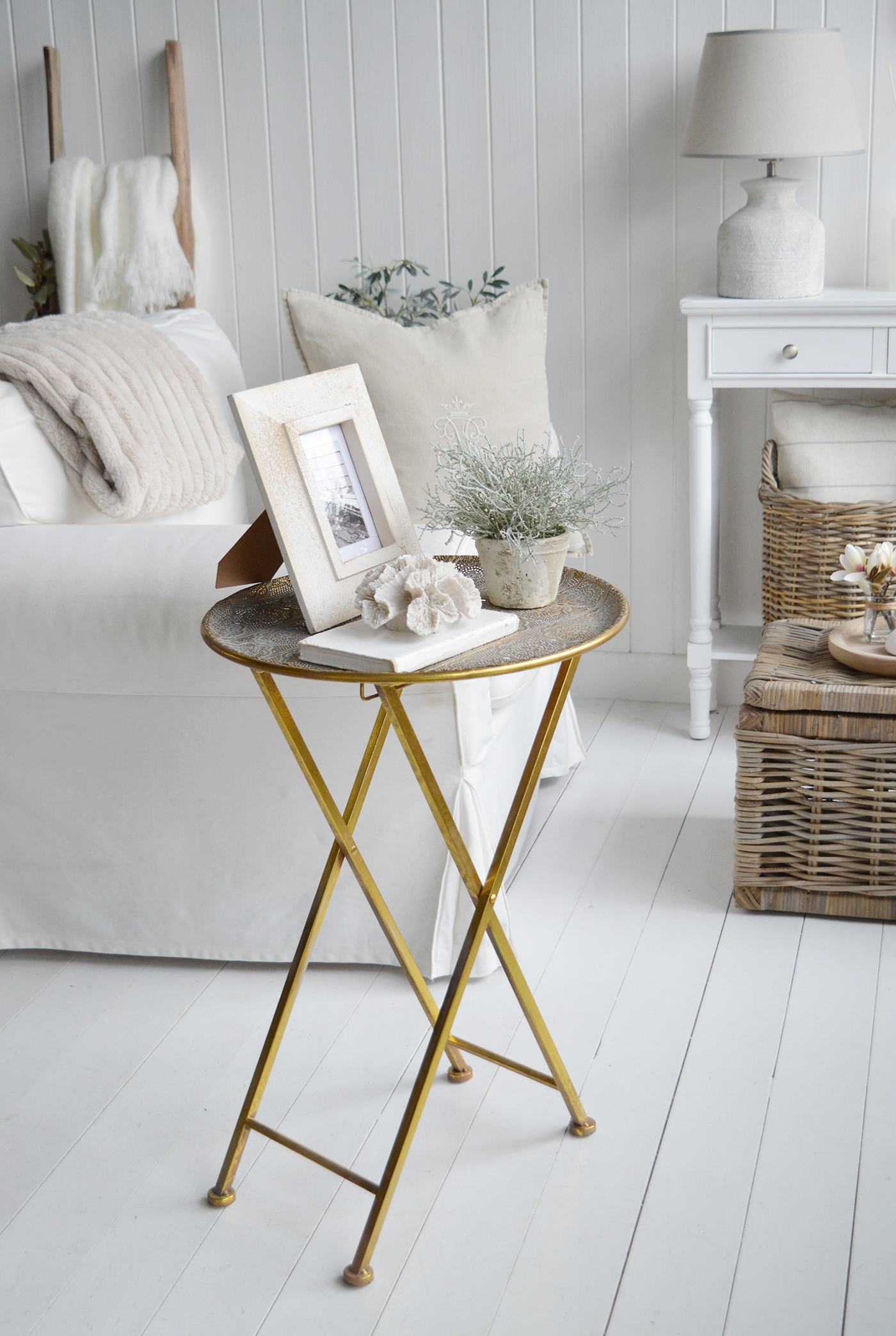 COntrasting Charleston antue gold table agains the neutral Hamptons living room interior decor