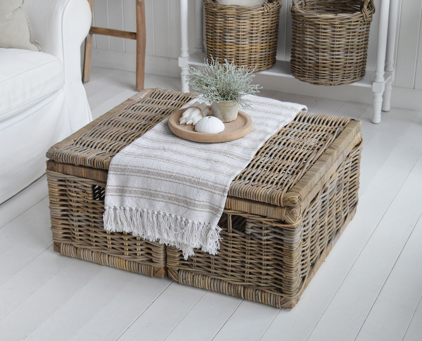 Two small Seaside coffee tables together to create a large storage area in this coastal living room