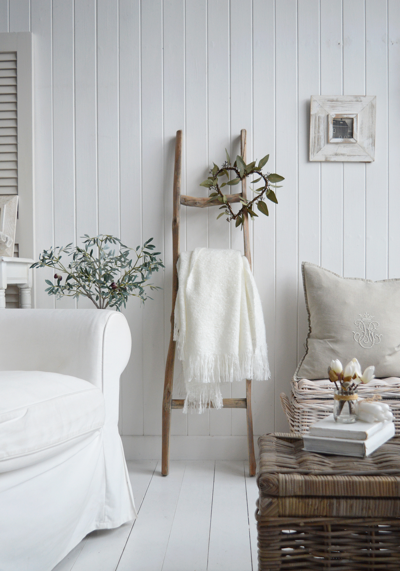 A coastal country living room with the wooden blanket ladder -  interiors in neutral decor for New England furniture and home accessories