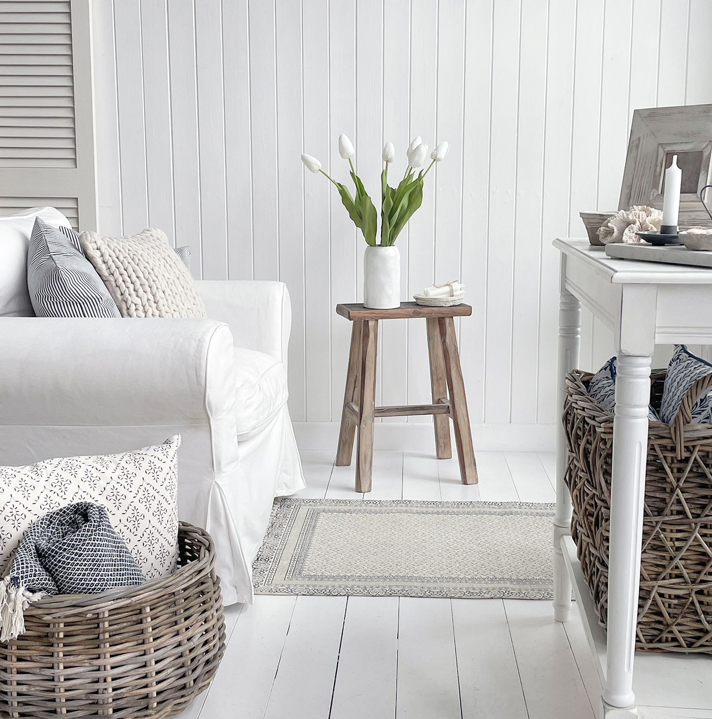 Seats and stools ...Texture galore in thei New England living room... baskets, throws and cushions