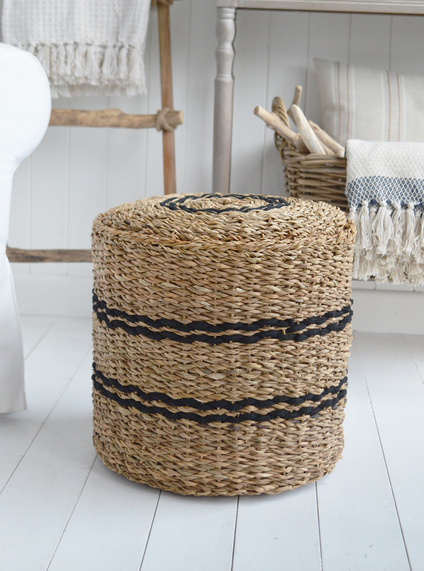 The Harrington Seagrass Pouffe adds natural texture to a modern coastal living room.