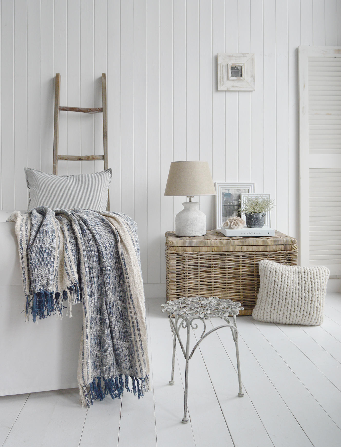 The Seaside willow table with storage shown in a New England style coastal living room. Shown alongside the Hudson blue and linen throw and Harvard table