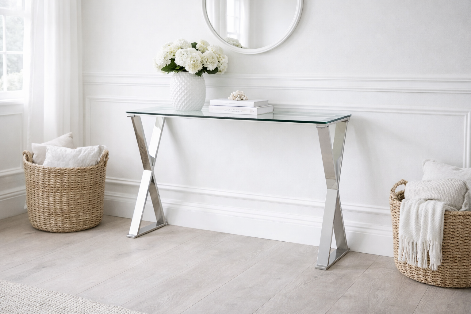 A refined glass console table with a sculptural stainless steel base, the Kensington design adds light and balance to hallways and living spaces.
