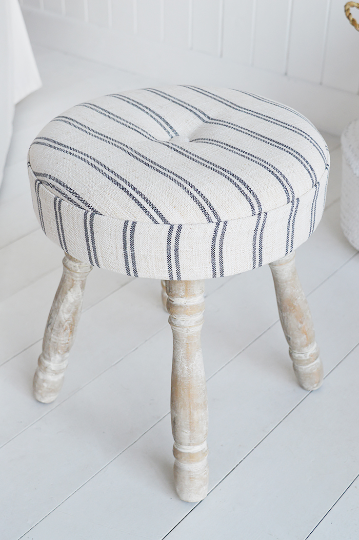 The Long Island small stool, padded and upholstered in ticking linen effect fabric with white washed turned legs.