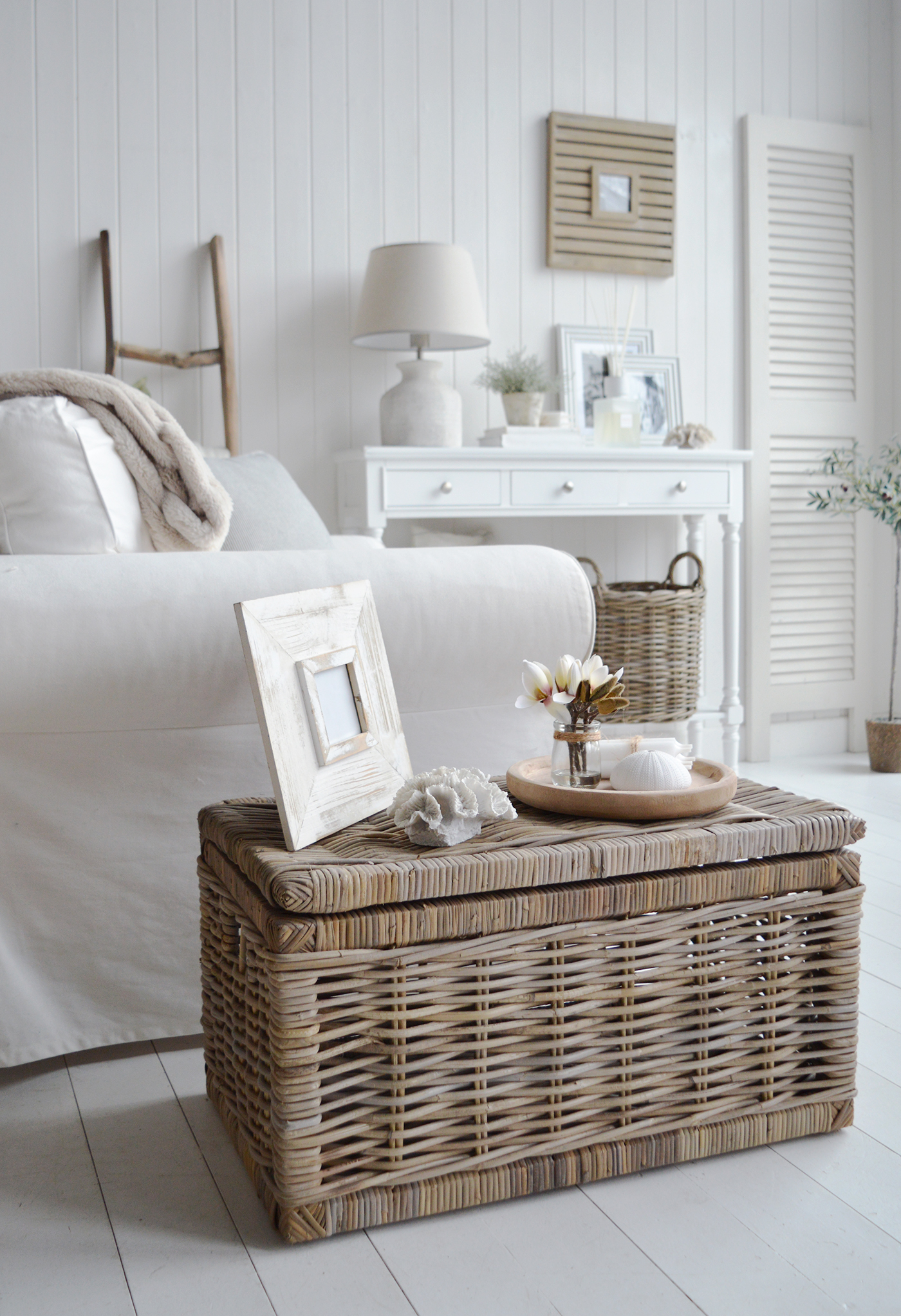 A modern farmhouse or castal living room with white furniture along with the Seaside basket table in gryed willow