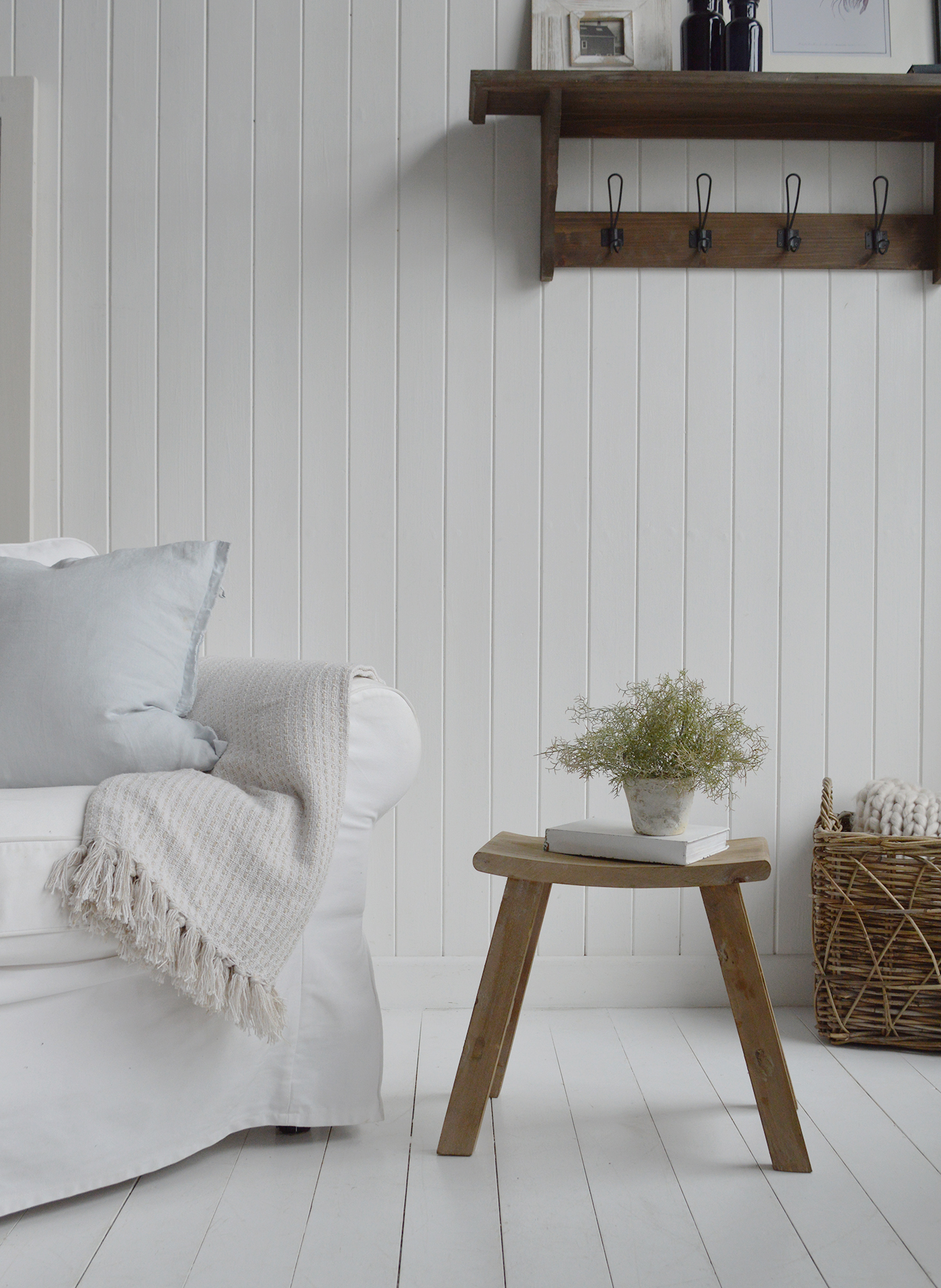 Pawtucket Natural wood stool with curved seat used as side table in New England-inspired home