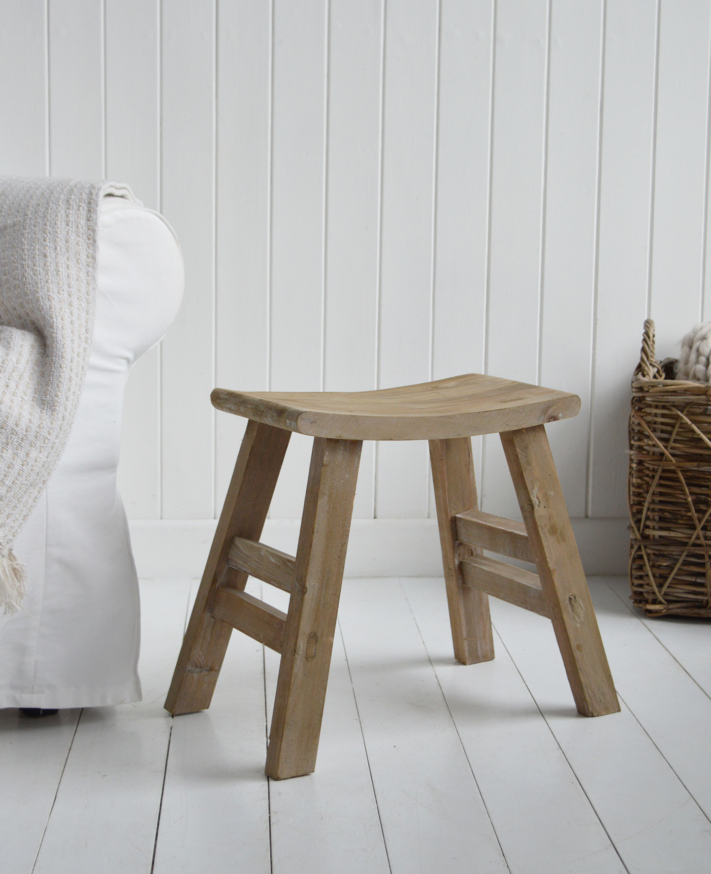 Multi-purpose Pawtucket wooden stool styled in whitewashed room with coastal décor accents