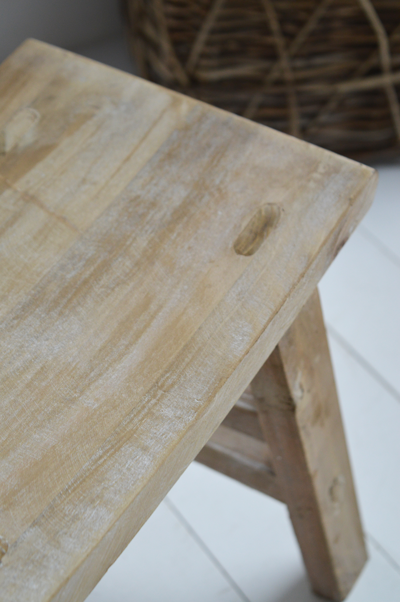 Neutral-toned wooden side table in relaxed Hamptons-style living space