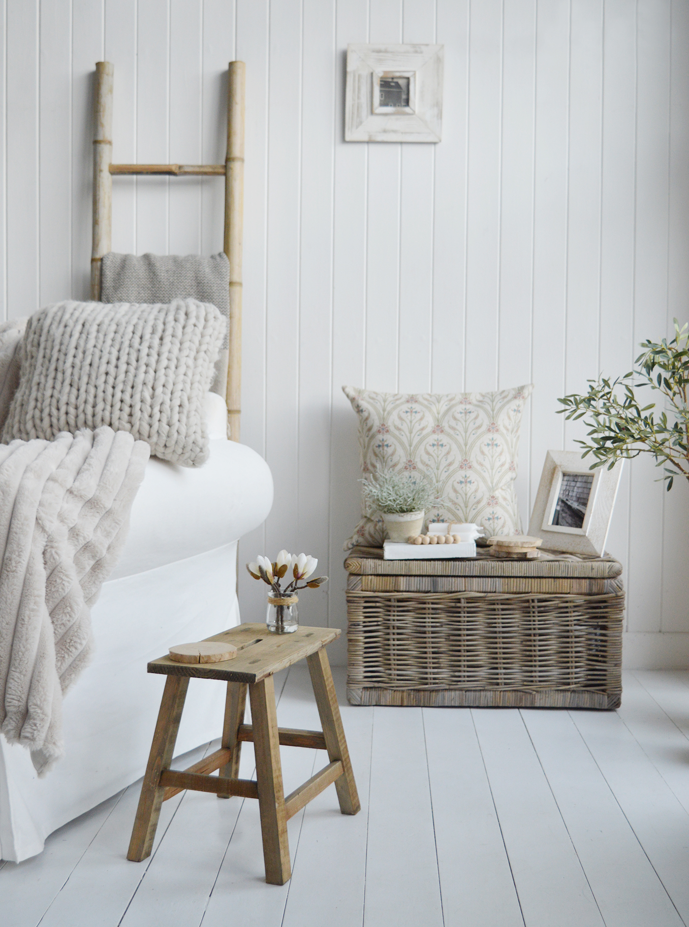 The Pawtucket milking stool as a small side table in a New England modern farmhouse or country living room, shown with our Seaside basket and home decor pieces to create a beautiful home