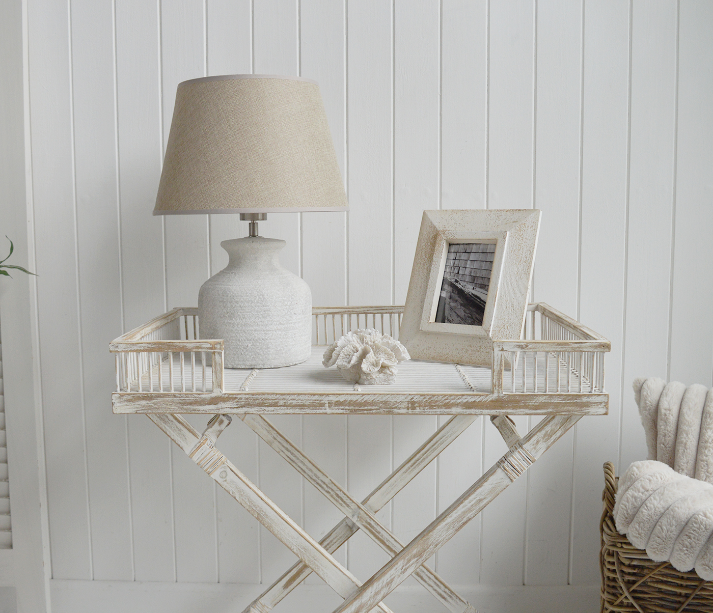 The Provincetown Table, a White wash beach house tray table, and ideal piece of furniture for coastal homes and interiors - shown here with neutral home decor accessories and a lamp