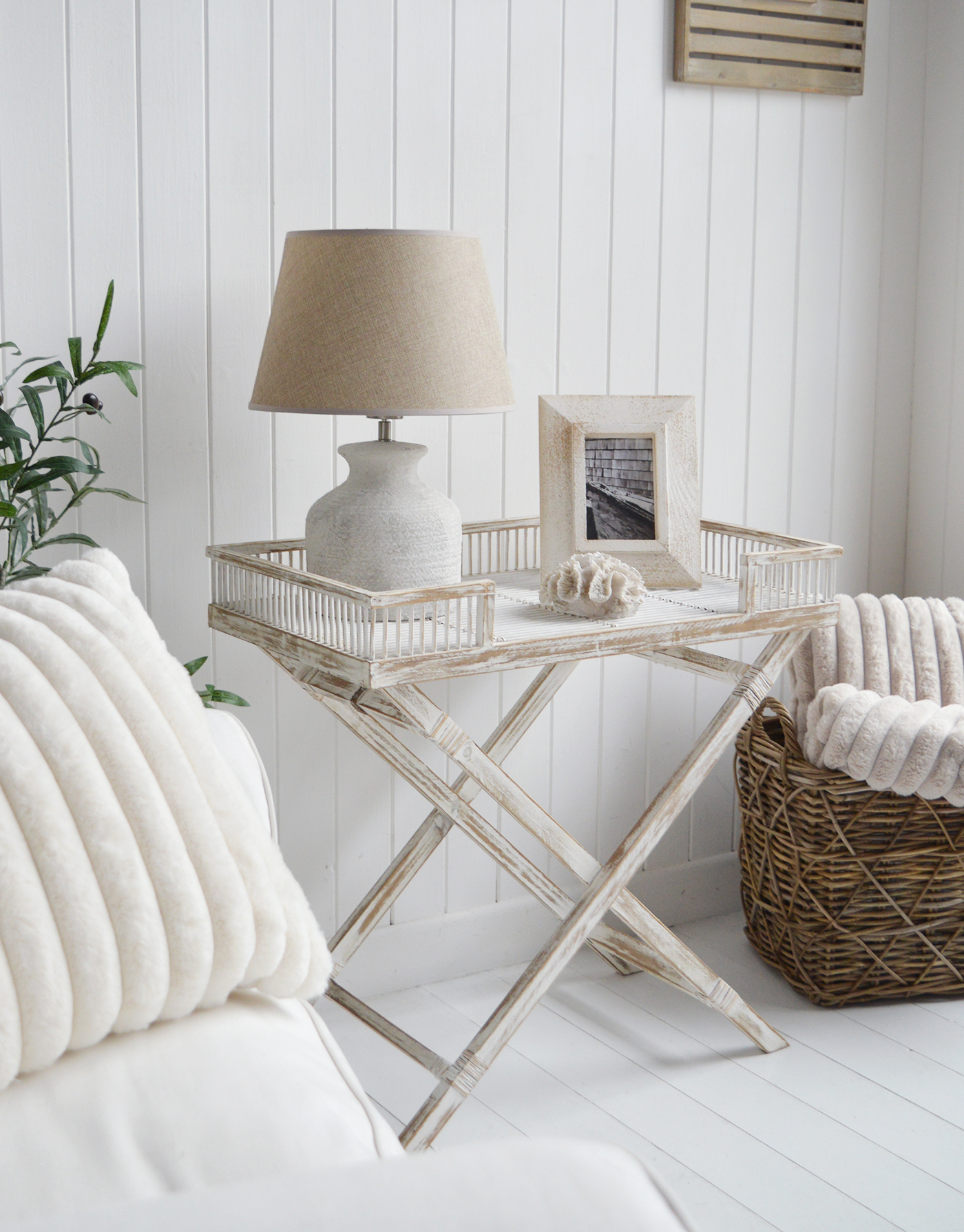 The Provincetown Table, a White wash beach house tray table, and ideal piece of furniture for coastal homes and interiors - shown beside a naturally grey coloured Casco Bay basket