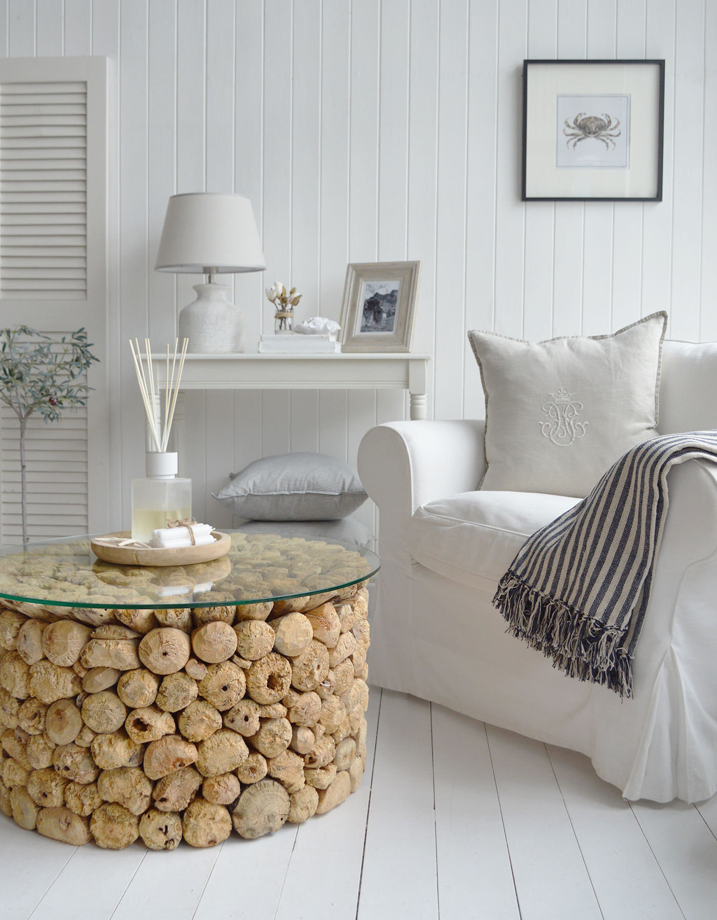 The Sag Harbor coastal coffee table, had crafted from pieces of driftwood in a Hamptons inspired living room by the sea