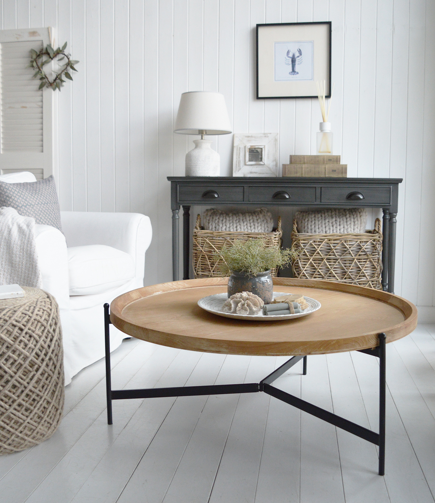 This coastal living space pairs the Greyhaven Console in Weathered Slate with the Salisbury Washed Wood Coffee Table, creating a perfect balance of depth and natural warmth