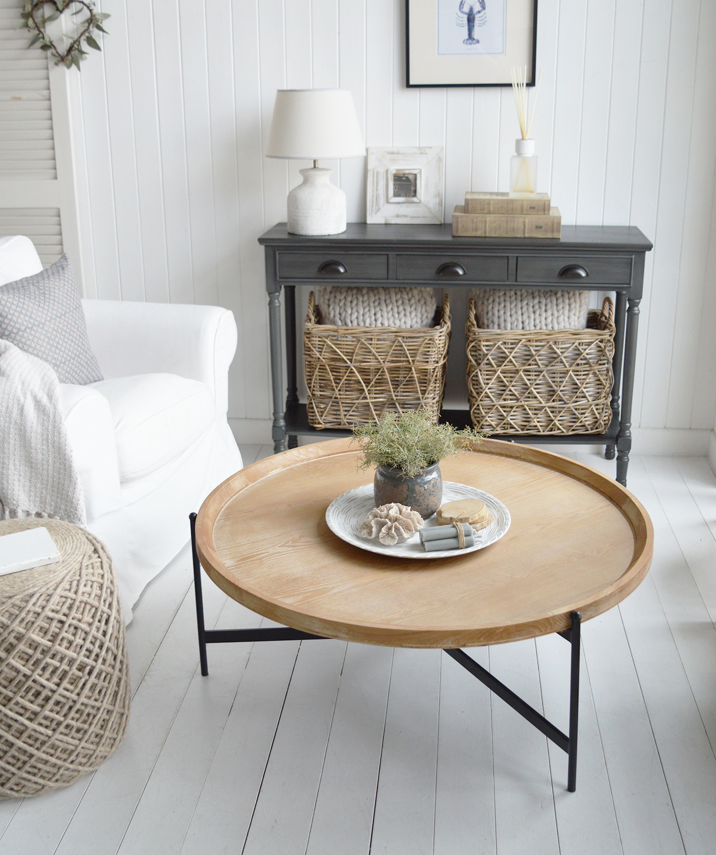 The Salisbury table’s gently washed wood finish adds a soft, organic texture that complements the white panelling, seagrass accents and relaxed New England palette.