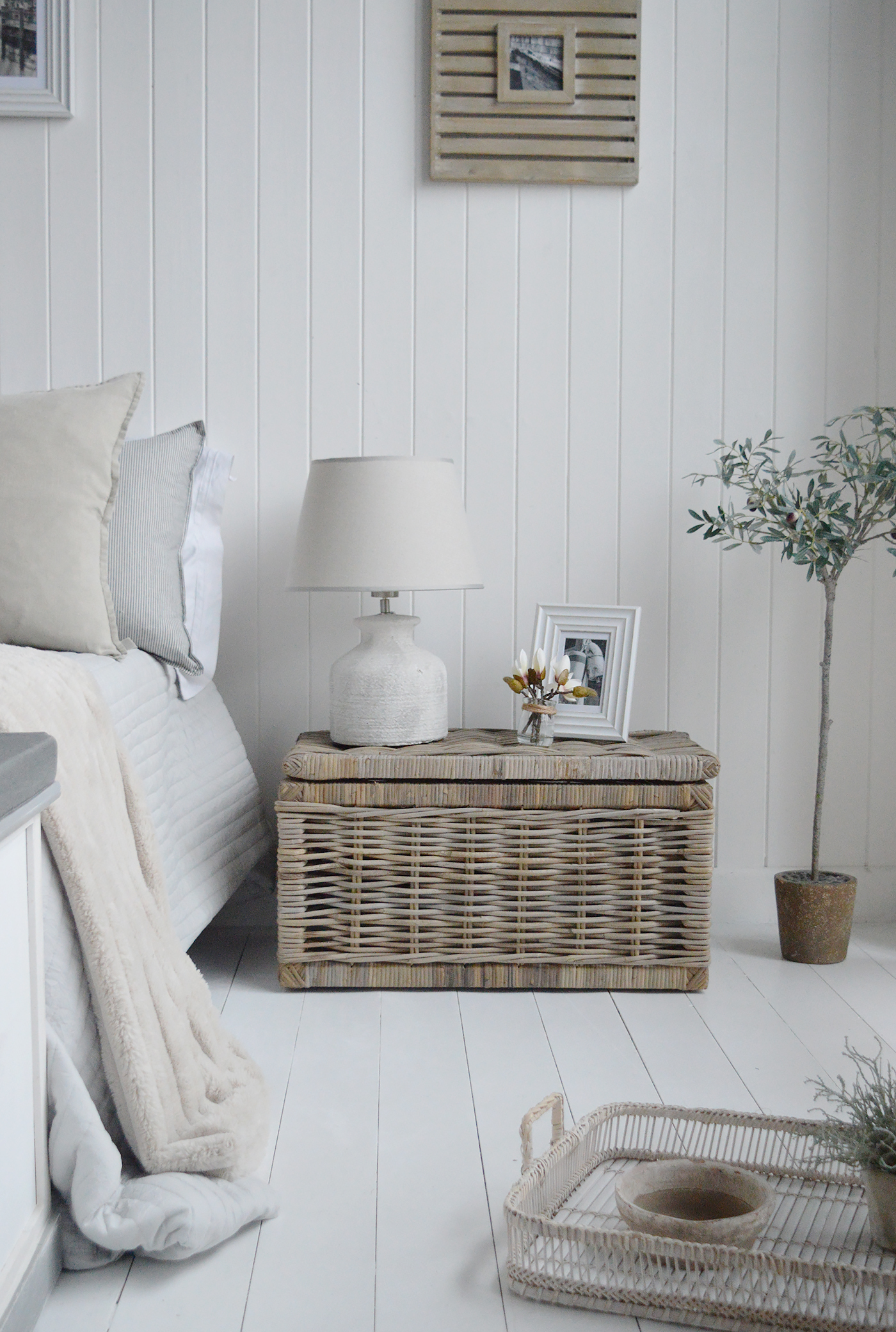 The Seaside basket as a bedside table in a modern country bedroom