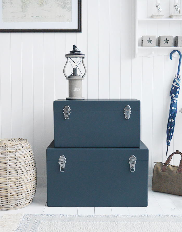 A set of two large different sized Newbury rectangle trunks in a luxurious dark blue grey colour in a matt finish with contrasting silver handles and clasps. The White Lighthouse New England Coastal and Country furniture and interiors. Bathroom, Living Room, Bedroom and Hallway Furniture for beautiful homes