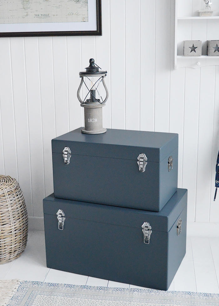 A set of two large different sized Newbury rectangle trunks in a luxurious dark blue grey colour in a matt finish with contrasting silver handles and clasps. The White Lighthouse New England Coastal and Country furniture and interiors. Bathroom, Living Room, Bedroom and Hallway Furniture for beautiful homes