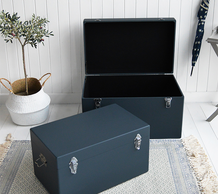 A set of two large different sized Newbury rectangle trunks in a luxurious dark blue grey colour in a matt finish with contrasting silver handles and clasps. The White Lighthouse New England Coastal and Country furniture and interiors. Bathroom, Living Room, Bedroom and Hallway Furniture for beautiful homes