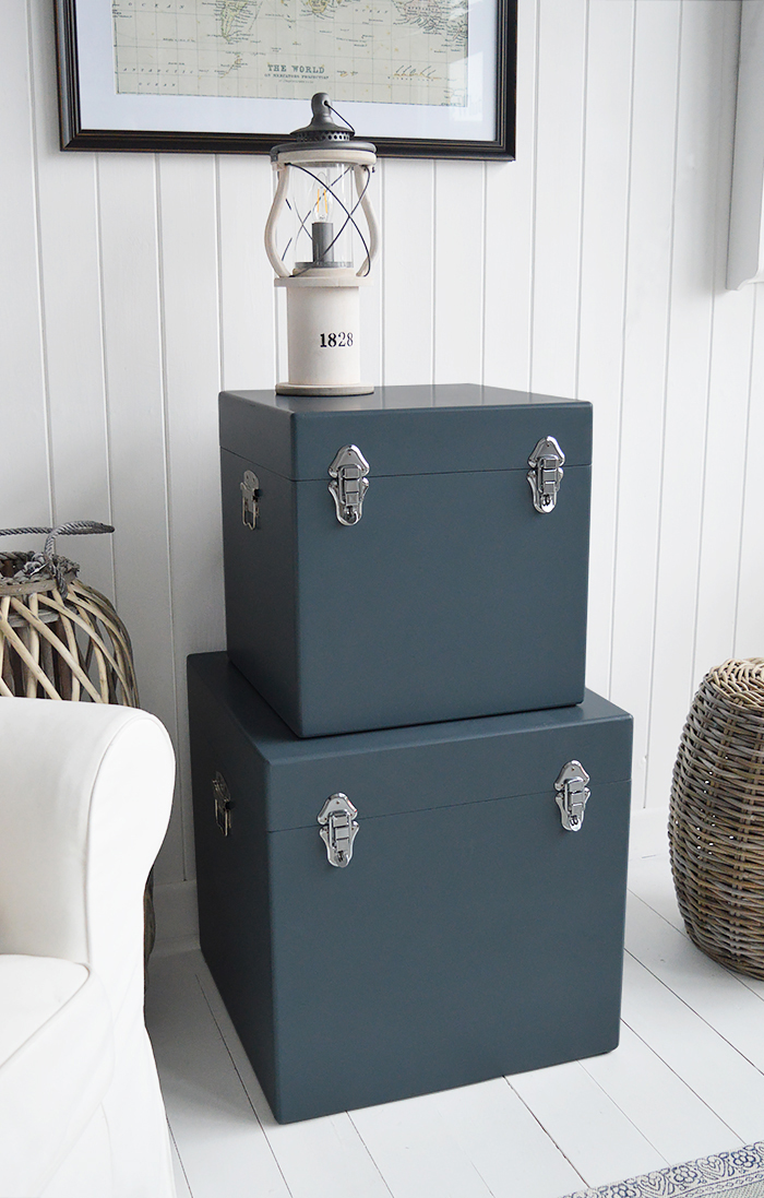 A set of two large different sized Newbury square trunks in a luxurious dark blue grey colour in a matt finish with contrasting silver handles and clasps. The White Lighthouse New England Coastal and Country furniture and interiors. Bathroom, Living Room, Bedroom and Hallway Furniture for beautiful homes