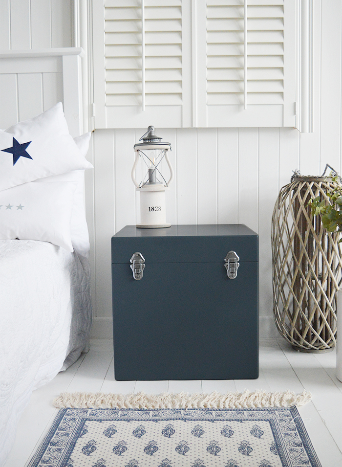 A set of two large different sized Newbury square trunks in a luxurious dark blue grey colour in a matt finish with contrasting silver handles and clasps. The White Lighthouse New England Coastal and Country furniture and interiors. Bathroom, Living Room, Bedroom and Hallway Furniture for beautiful homes as a bedside table