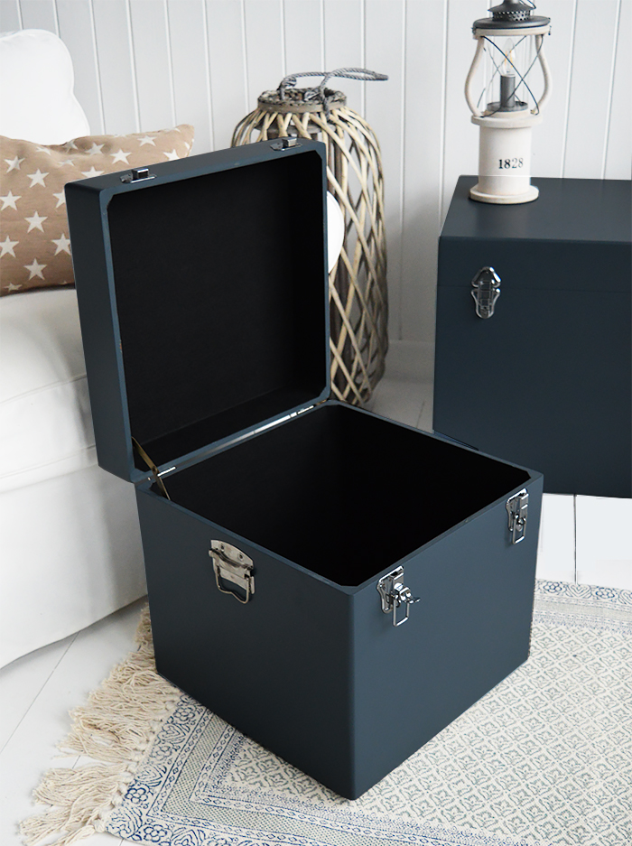 A set of two large different sized Newbury square trunks in a luxurious dark blue grey colour in a matt finish with contrasting silver handles and clasps. The White Lighthouse New England Coastal and Country furniture and interiors. Bathroom, Living Room, Bedroom and Hallway Furniture for beautiful homes